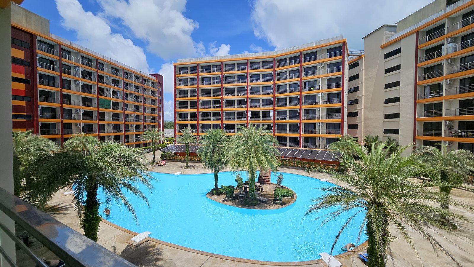Pool and palm garden between the buildings of 777 Beach Condo